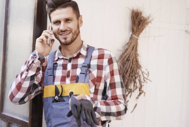 Cep telefonuyla konuşurken neşeli bahçıvan 