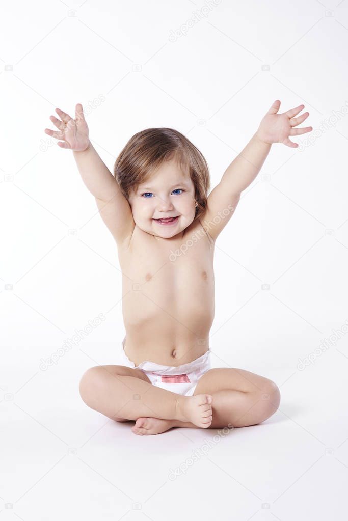 Child with hands up sitting at studio shot  