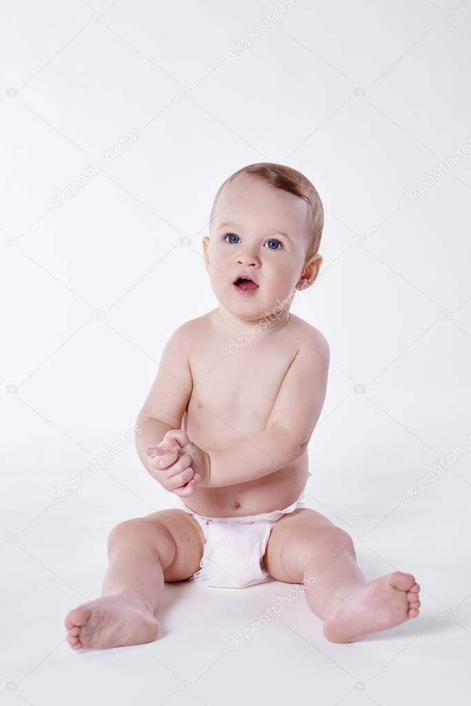 Confused baby boy sitting at studio shot 