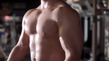 Athlete lifting a barbell at gym/