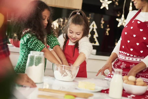 Family baking cookies together in Christmas time