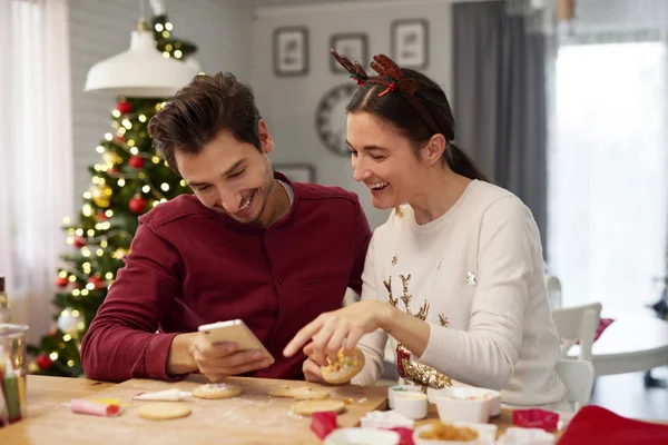 Пара Мобільним Телефоном Прикрашає Різдвяні Печиво — стокове фото