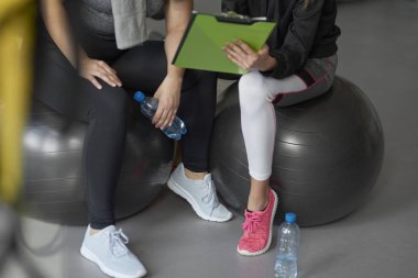 Personal trainer guiding sports woman  clipart