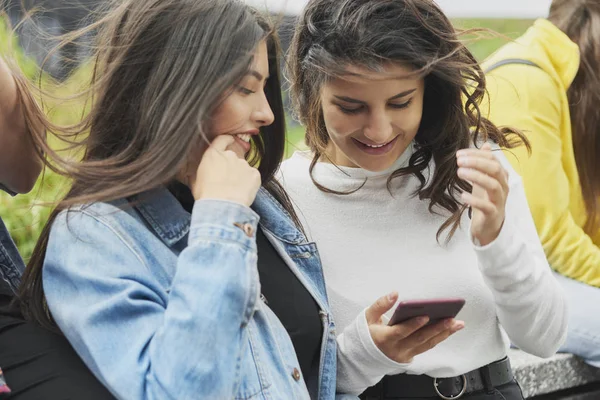 Two Young Women Using Mobile Phone Outdoors — 스톡 사진