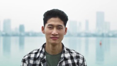 Vietnamlı bir gencin kameraya baktığı el kameralı video şovlar. 8 km 'de kırmızı helyum kamerayla çekilmiş.