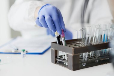 Desk at laboratory with test tubes clipart