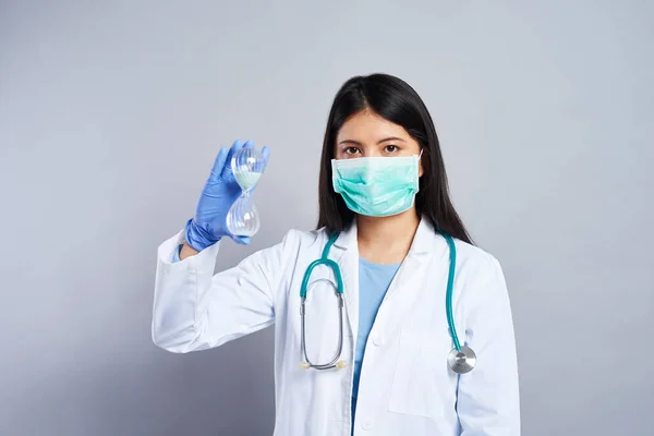 Female Asian Doctor Holding Hourglass — Stock Photo, Image