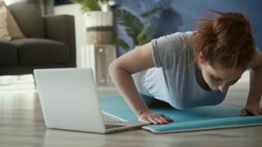 Evde şınav çeken kadının statik videosu.