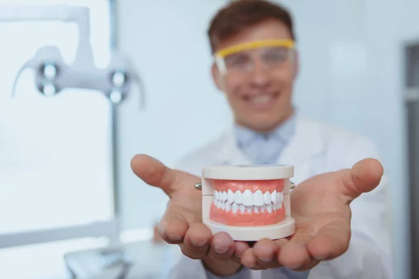 Handsome male dentist working at his clinic — Stock Photo, Image