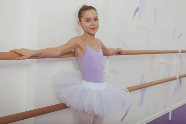 Gorgeous young girl ballerina practicing at dance studio