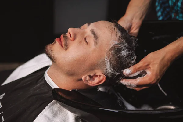 Mature man getting a new haircut at the barbershop — Stock Photo, Image