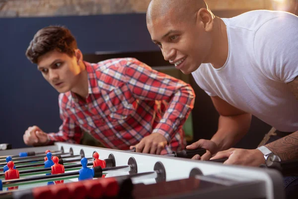 Group of friends playing table soccer at beer pub — Stock Photo, Image