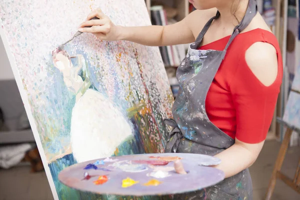 Unrecognizable female painter drawing an artwork at her studio. Art, imagination concept