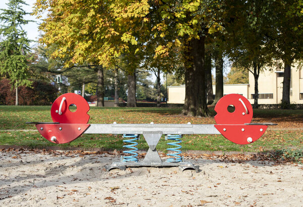Seesaw, teeter totter consisting of a board balanced 