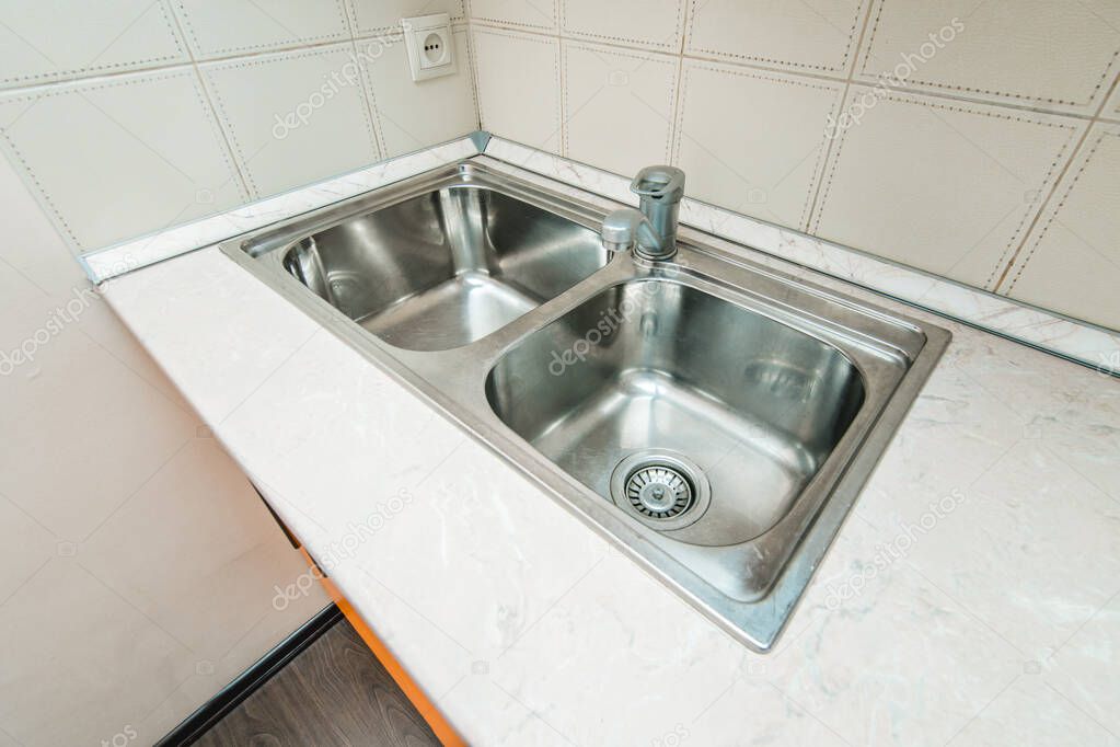 The photo of a sink in a The photo of a sink in a  kitchen