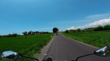 Asfaltlı bir yolda motosiklet sürmek.