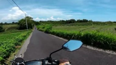 Asfaltlı bir yolda motosiklet sürmek.