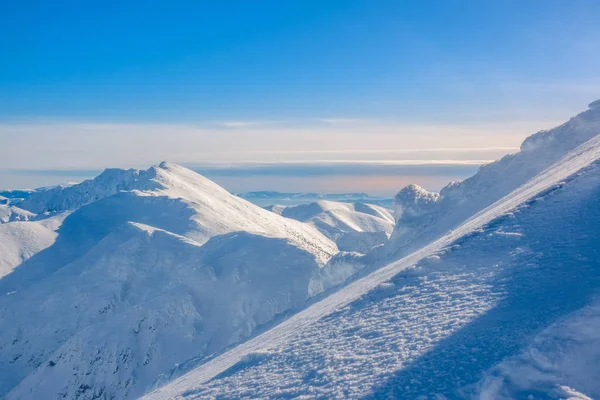 Крутая лыжная трасса на фоне горных вершин — стоковое фото