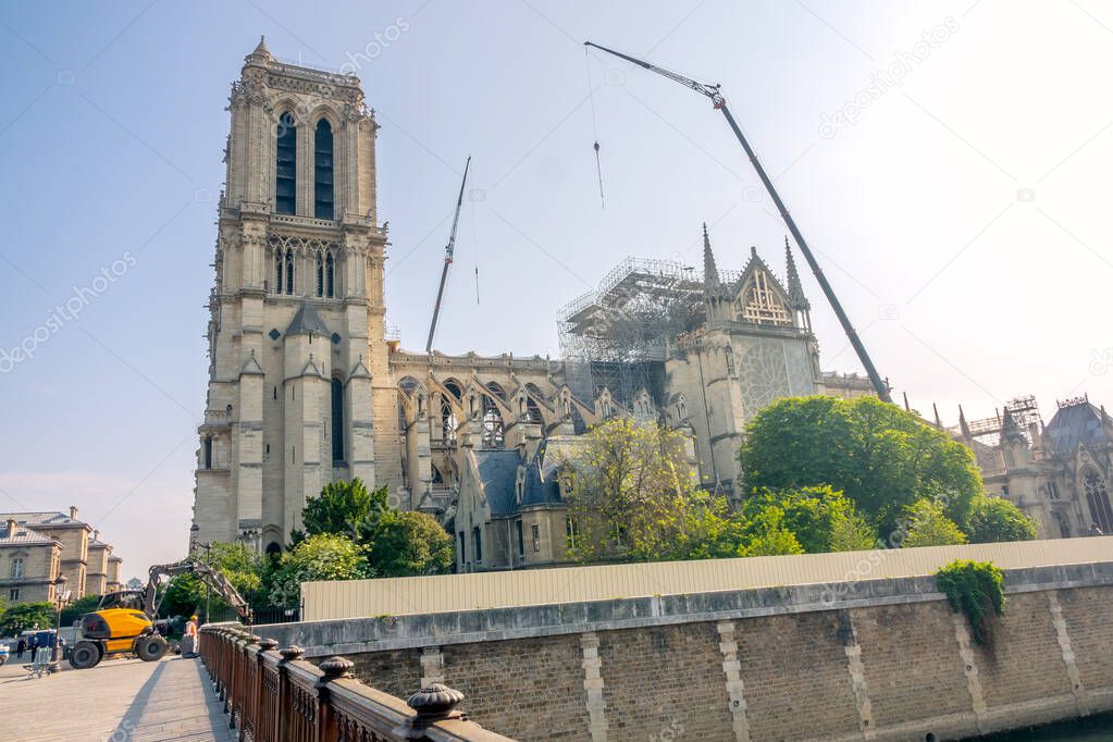 France. Summer sunny day in Paris. Cranes and other construction equipment to repair Notre Dame after the 2019 fire