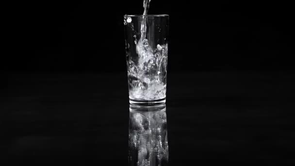 Glass Goblet Water Pours Splashes Black Background Slow Motion — Stock Video