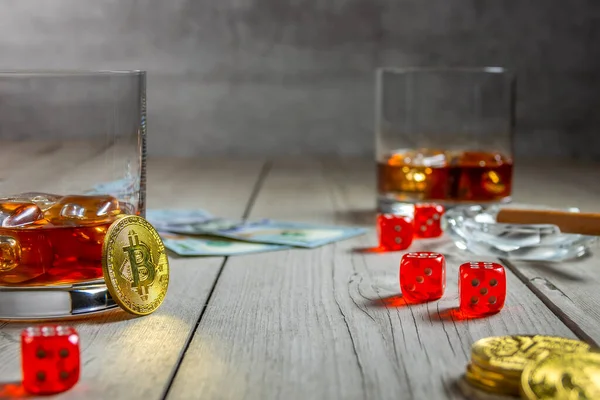 Kırsal ahşap masa. İki bardak buzlu viski ve kül tablasında bir puro. Dolarlar ve zarlar. Birkaç bitcoin madeni para