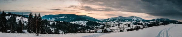 Snow-capped houses in mountains Carpathians Ukraine