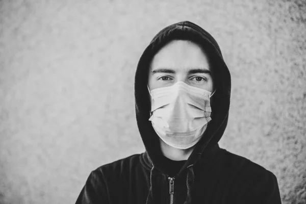 コロナウイルス 壁の背景に医療用保護マスクを着た男 Covid インフルエンザの予防 ウイルス パンデミック パニック概念 健康を守るんだ 隔離の概念 白黒写真 — ストック写真