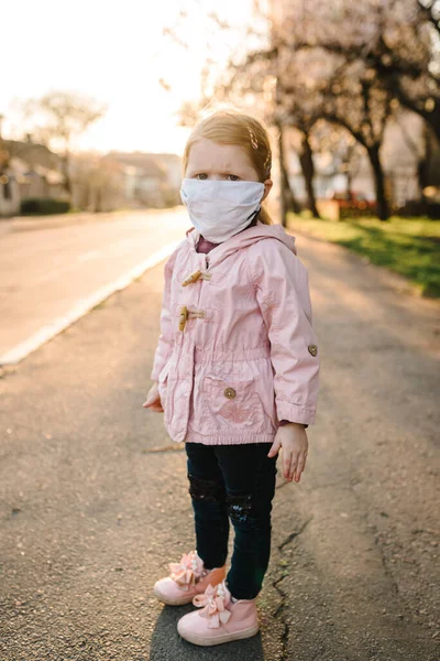 Coronavirus and virus epidemic diseases. Healthy child in medical protective mask in the street. Health protection and prevention during flu and infectious outbreak. Stay at home save your life.