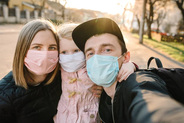 Coronavirus the end concept, virus disease. Healthy family with child in medical protective mask in the street. Health protection and prevention during flu and infectious outbreak. No more covid-19.