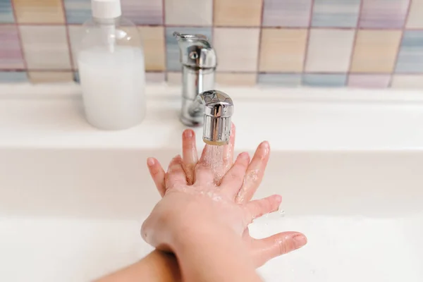 Washing hands and hygiene. Coronavirus, flu disease prevention. Wash womans hands with antibacterial soap, warm water rubbing nails and fingers in sink. Covid-19. To stop spreading coronavirus.