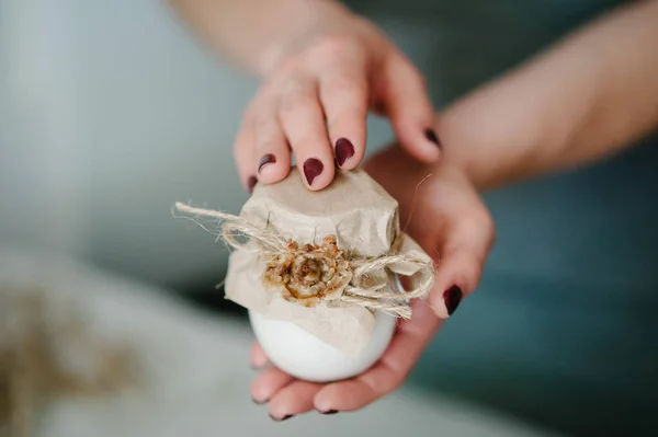 Hands girl holding in little jar of skin cream or bottles lotion, natural cosmetics. Cosmetology, beauty and spa. Wellness. Close up. selected focus.