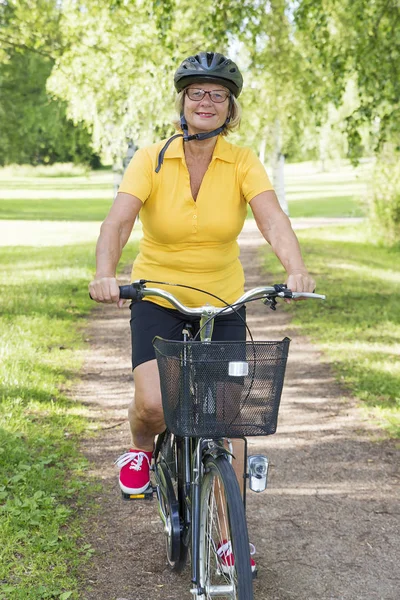 Adatto donna anziana in bicicletta al parco — Foto Stock