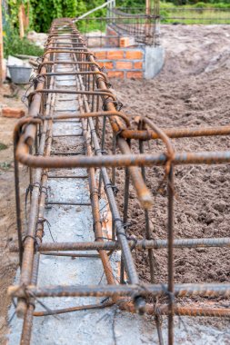 Foundation site of new house, building, details and reinforcements with steel bars and wire rod, bricklayering of wall
