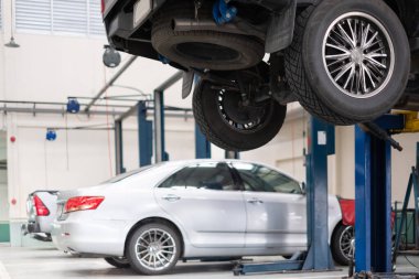 Car lift up for repair at car repair service shop