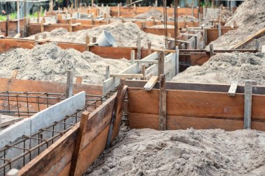 planks are used to set up for creating ground beam for house bui