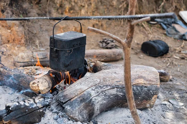 Cooking in a pot on the fire when hiking to mountain.