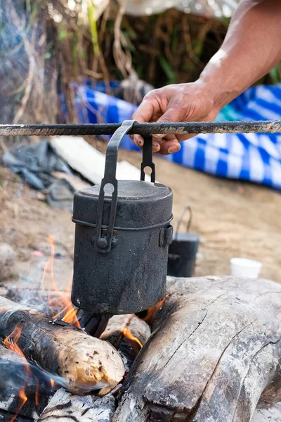 Cooking in a pot on the fire when hiking to mountain.