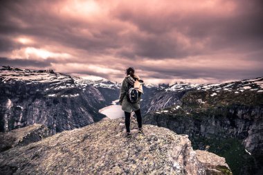 July 22, 2015: Traveller at the edge of Trolltunga, Norway (EDITORIAL CONTENT ONLY) clipart