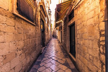 July 17, 2016: A narrow cobblstone street in the old town of Dubrovnik clipart