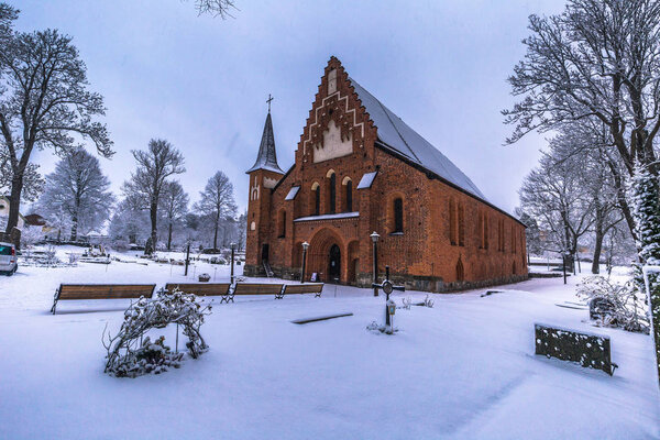 December 10, 2016: The red Saint Mary's church in Sigtuna in winter, Sweden