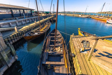 Roskilde, Denmark - May 01, 2017: Viking long boats in the harbor of Roskilde clipart