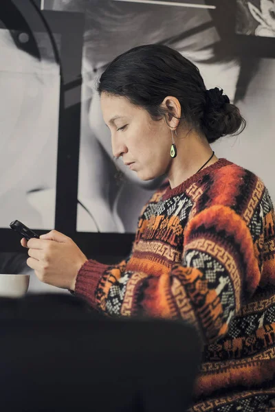 Profile picture of a distracted woman with wool sweater