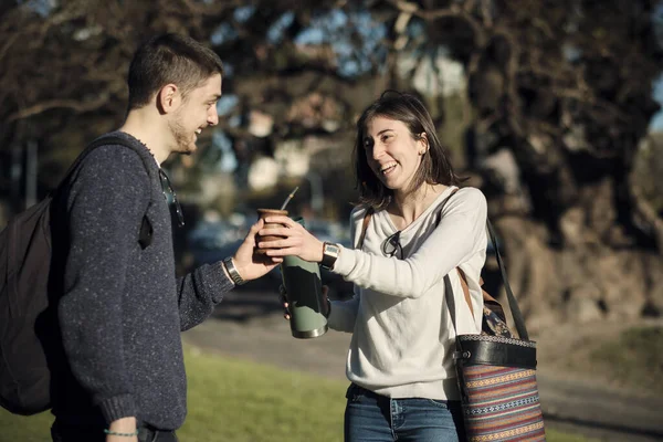 Friends or couple meet in an outdoor park to share a tea, Argentina Buenos Aires