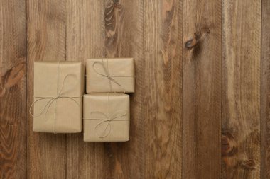 Gift boxes on wooden background, top view clipart