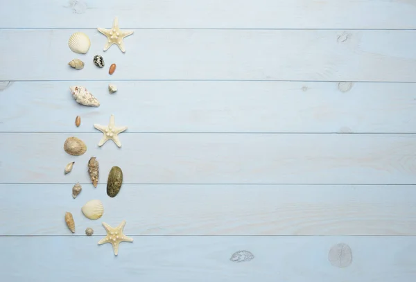 Conchas de mar, estrellas de mar y conchas de mar sobre fondo azul de madera — Foto de Stock