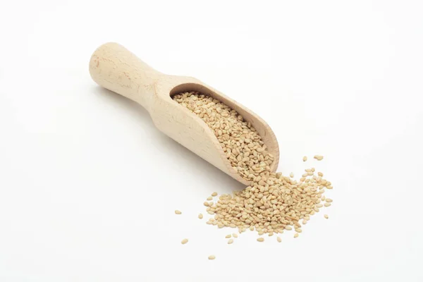 Natural sesame in a wooden spoon — Stock Photo, Image