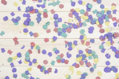 Confetti on white wooden background
