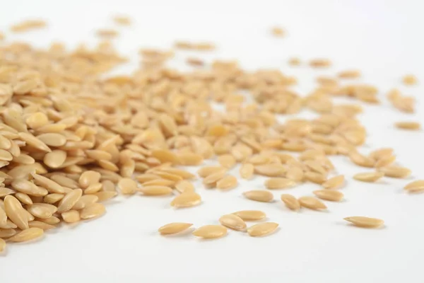 Golden flax seeds on white background — Stock Photo, Image