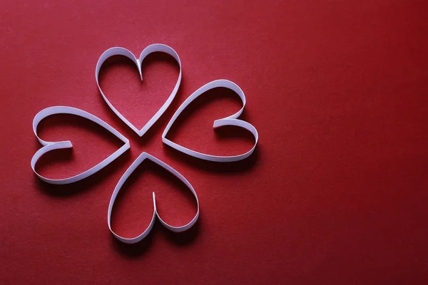 Shamrock forma feita de listras de papel, fundo vermelho — Fotografia de Stock