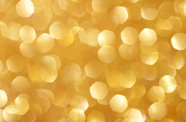 Złote błyszczące lampki świąteczne. Zamazane abstrakcyjne tło — Zdjęcie stockowe